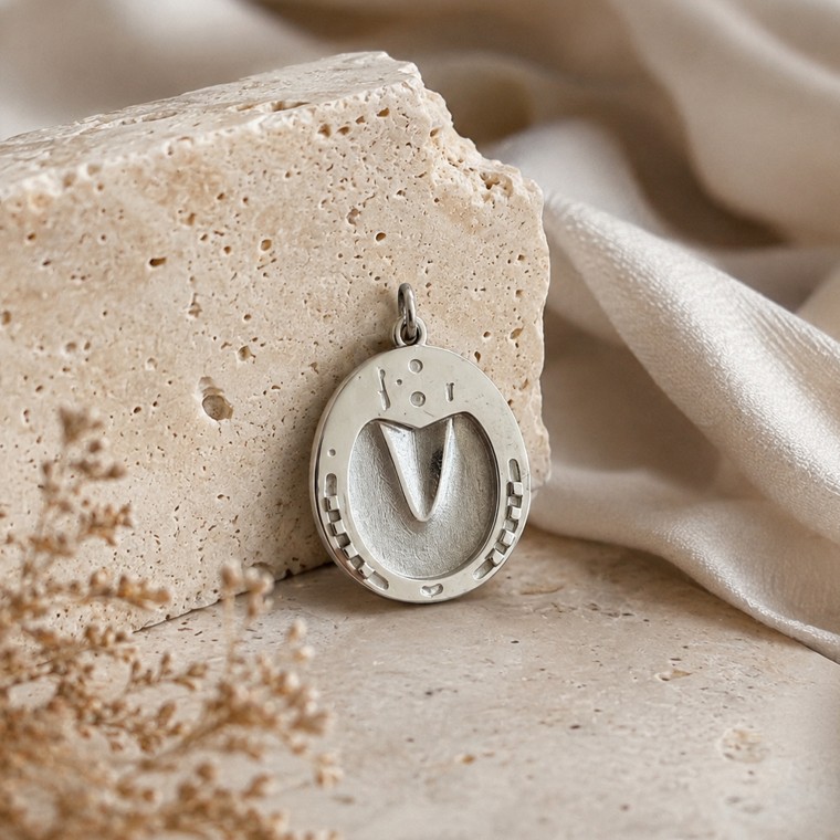 Sterling silver hoofprint pendant styled on stone and silk